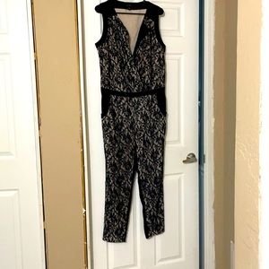 Jumpsuit, with black lace overlay. Skin color Lng.